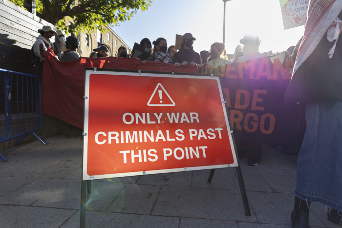Huge banner outside the Royal Courts of Justice stating "STOP ARMING ISRAEL"