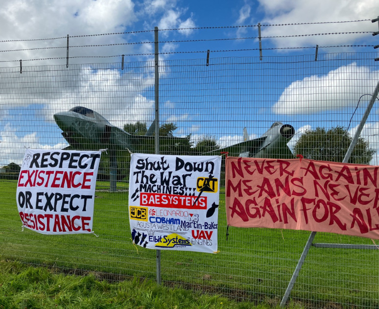 Banner hung on a security fence protecting BAE Systems