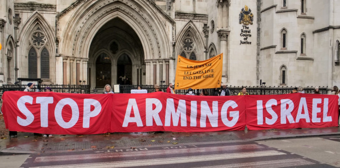 Huge banner outside the Royal Courts of Justice stating "STOP ARMING ISRAEL"