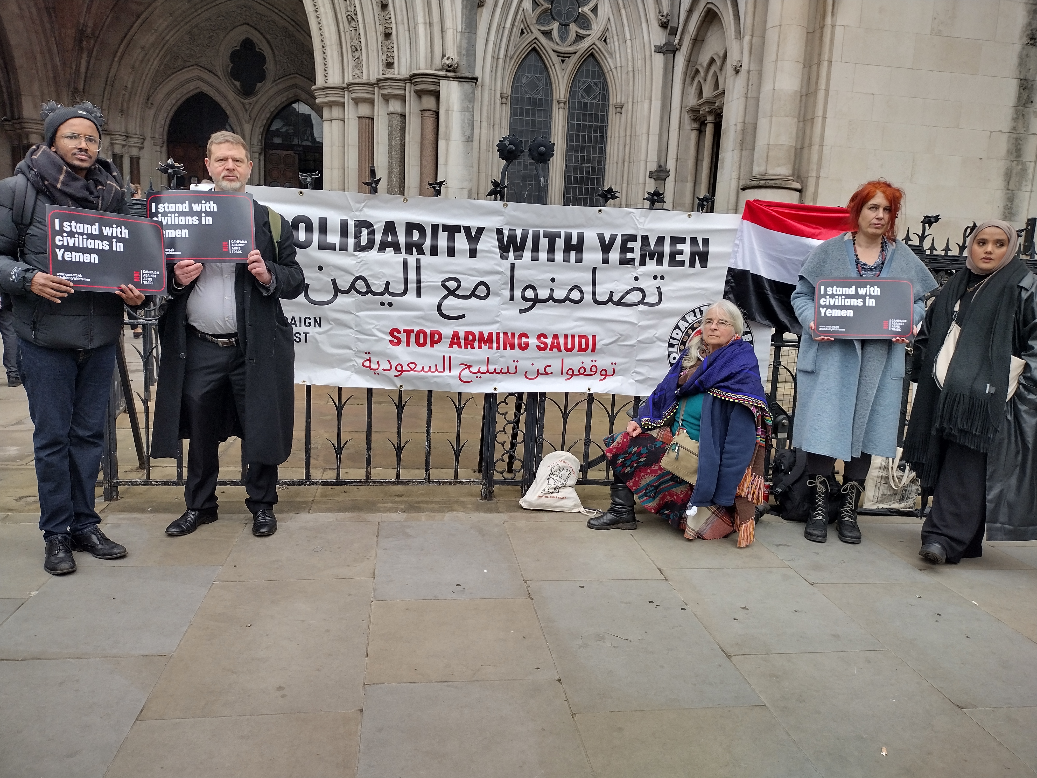 Protesters outside the Royal Courts of Justice with a "Solidarity with Yemen - Stop Arming Saudi" banner