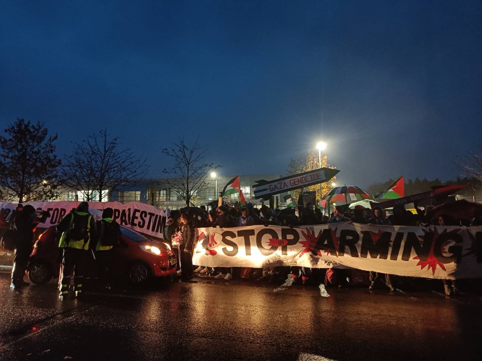 Protesters with a Stop Arming Israel Banner, early morning outside Mission Systems Dorset