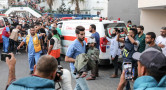 Recent image of chaotic scenes of hospital in Gaza with a young injured child being carried in.